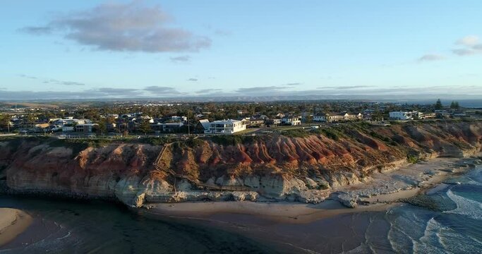 Forward tracking aerial view of The Onkaparinga River and city of Port Noarlunga with wooden walkway leading to Noarlunga beach, Adelaide, South Australia,Australia