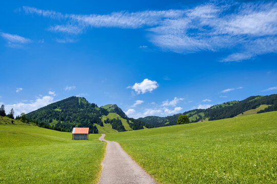 hiking trail in idyllic summer landscape allgaeu Alps