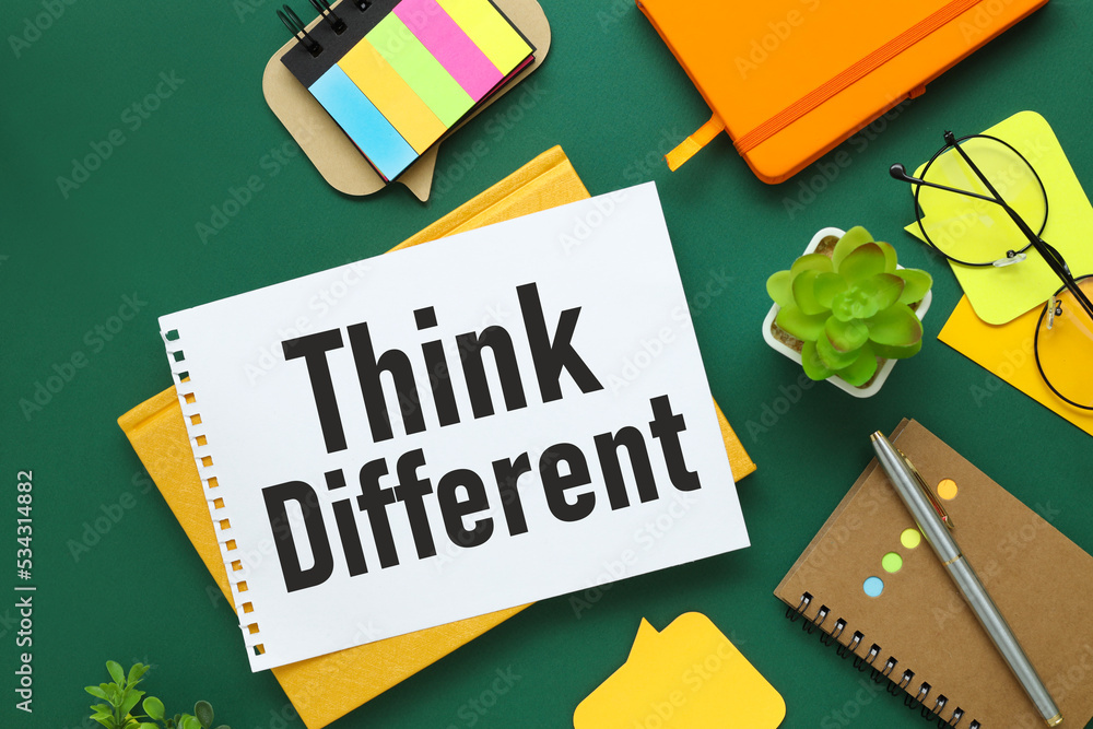 Poster think different. word on a notepad with a spring on a green and yellow background with bright statio