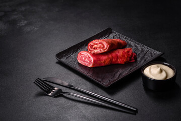 Delicious fresh red pancakes topped with beetroot juice with cheese and eggs