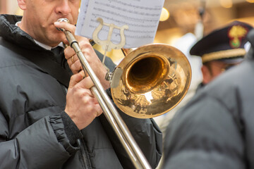 Obraz premium Musician From A Popular Band Playing Trumpet During A Religious Procession