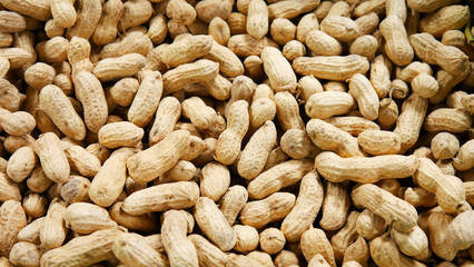 A large pile of unpeeled peanuts