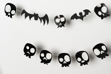 Bats and skulls black on white background, place to write greeting.
