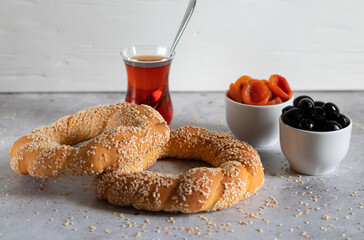 Traditional Turkish bagel - Simit with tea, dried apricots and black olives