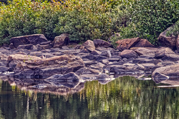 Water acts as a reluctant mirror when it flows , Thunder Bay, ON, Canada