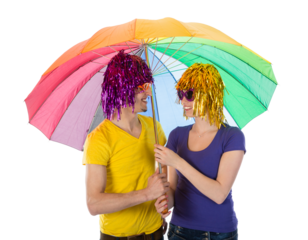 Trendy couple with sunglasses and wigs covered under a rainbow unbrella isolated on transparent background