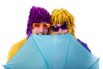 Trendy couple with sunglasses and wigs protected by an umbrella isolated on transparent background