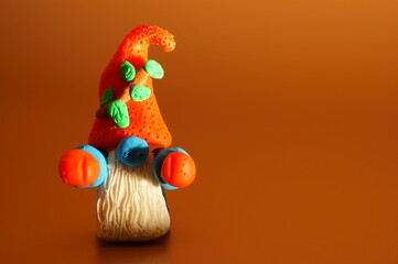 A figure of a dwarf on a bright background. Christmas toys and decorations.