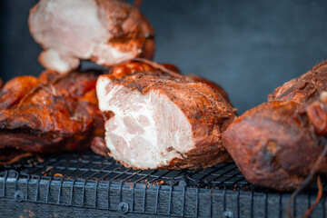 Smoked pork neck. Street food. Meat in the smokehouse. Dark crust with spices. Natural meat product produced by traditional methods