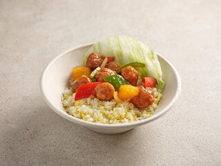 Sweet and Sour Pork with Egg Fried Rice served in a dish isolated on table side view