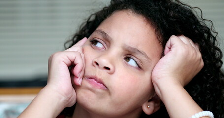 Child thinking about solution, pensive kid thoughtful girl