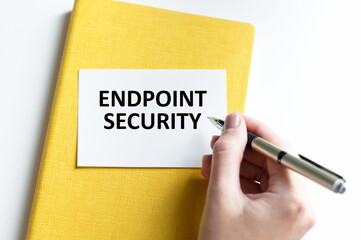 Business concept. Text ENDPOINT SECURITY The text on the card is written by the hand of a person on a bright table