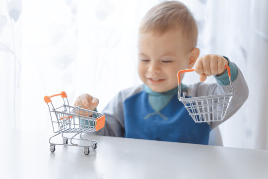 Mall shopping. Buy products. Child playing shopping trolley cart, basket. Play shop game. Cute buyer customer client hold shopping cart. Buy with discount. Shopping, discount, sale concept