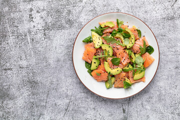 Salmon salad with avocado,  for keto and low carb diet. Rusty background, top view, copy space.