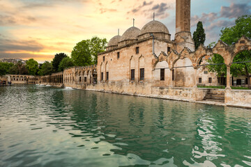 Balikligol (The Fish Lake in English) in Sanliurfa, Turkey, with sunset sky.  The historic Pool of...
