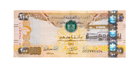 Closeup of UAE 200 dirhams currency notes on light wooden table from high angle, paper money