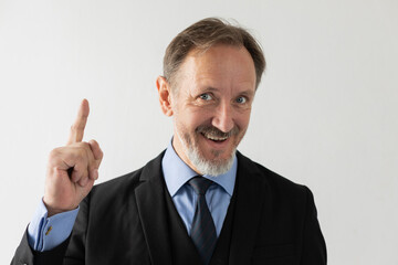 Portrait of happy mature businessman having idea. Successful senior Caucasian manager wearing formal suit getting solution. Idea and solution concept