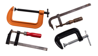 Four different clamps for joining wood on an isolated background.