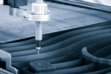 Cutting of metal with sparks fly from laser, modern industrial technology concept