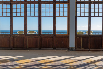 The Mediterranean sea through windows of a derelict hotel