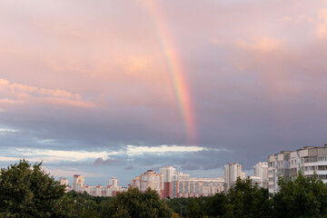 Rainbow in the cloudy sky over the city