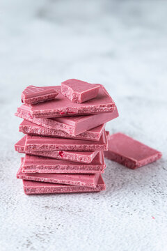 Pink or ruby chocolate, trendy dessert on grey background