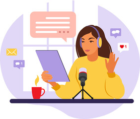 Female podcaster talking to microphone recording podcast in studio. Radio host with table.