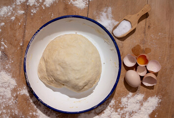 fresh dough making and dough ingredients on wooden floor