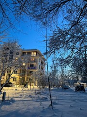 apartment building in winter with snow during white polar nights