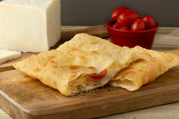 Delicious and traditional Brazilian snack pastel of cheese and tomato.