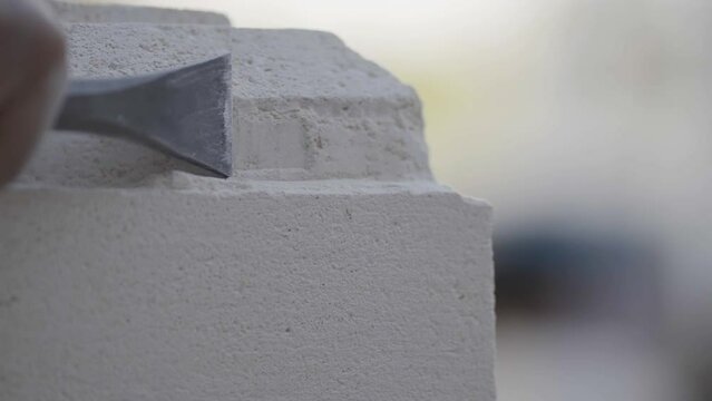 Chisel running along side of stone sculpture closeup