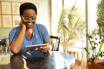 Smiling African American using digital tablet 