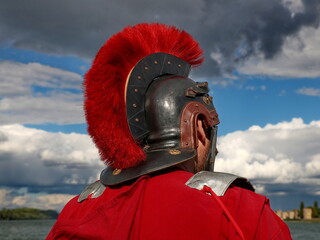 Roman soldier wearing an iron helmet and a red cloak