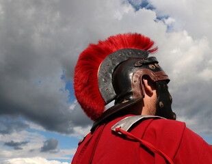 Roman soldier wearing an iron helmet and a red cloak