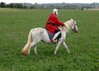 Soldier of the army of the Roman Empire riding on a white horse