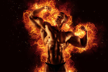 Bodybuilder posing on the fire flames background