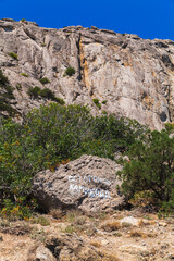 Russian text on a stone: Be careful, rockfall