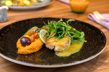 typical salvadorean food and drinks, sea bass on carrot purée