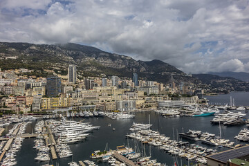 Fototapeta na wymiar Beautiful panoramic view on Monaco at daytime with Hercules Port (Port Hercule). Principality of Monaco, French Riviera, Western Europe.
