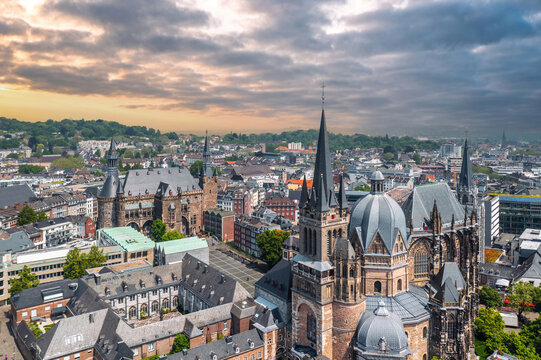 Sunset skyline of Aachen (Germany). Aerial view of Aachen Cathedral (German: Aachener Dom) with Katschhof square and Town Hall (Rathaus) in background