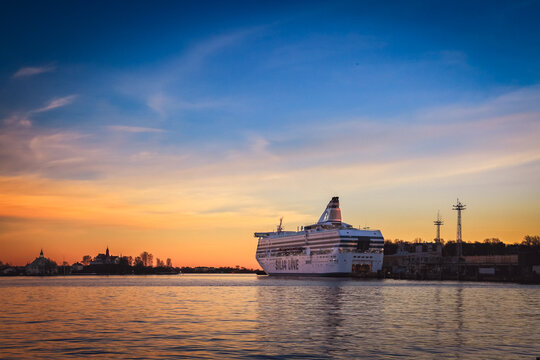 Helsinki, Finland - November 7, 2017: Modern ferry boat "Silja Line" moored at pier in blue water. Gulf of Finland at autumn colorful dusk. Scandinavia, Suomi, Helsingfors. Beautiful scenery. 