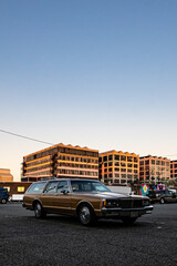 Fototapeta premium Flashy old car at an industrial park during sunset