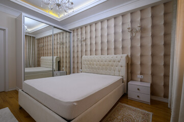 Fototapeta na wymiar Luxury well designed modern beige master bedroom