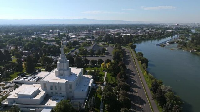 Aerial video of the Idaho Falls Temple next to Snake River in Idaho Falls, USA