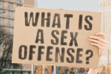 The question " What is a sex offense? " is on a banner in men's hands with blurred background. Assistant. Cruel. Dangerous. Despair. Employer. Horror. Job. Justice. Negative. Protect. Protection