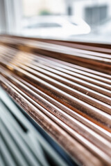 Copper pipe lying on the shelf, selective focus