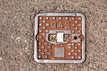 Manhole cover of the gas pipeline system. A massive metal hatch for access to city communications...