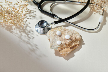 Stethoscope with natural, delicate beige background and props. Health care and medicine concept......
