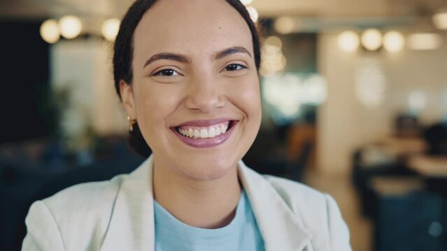 Close-up video of a lovely successful confident brazilian or hispanic woman, in formal wear, business lady, top manager of company, sits in the office, looks at camera, with a sincere positive smile