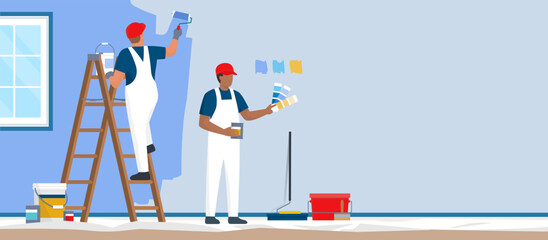 Professional painters and decorators painting a wall © elenabsl